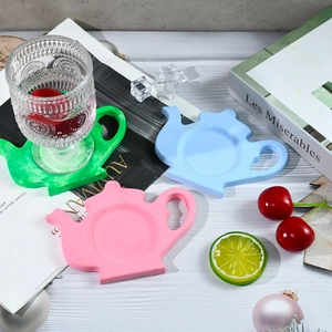Silicone teapot coasters in green, pink, and blue, perfect for heat-resistant home decor