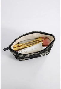 Internal view of large capacity makeup bag showing brushes and skincare storage
