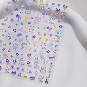 Macro detail of embossed 5D nail art stickers featuring cute rabbits and purple flowers