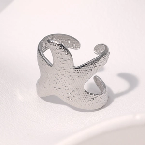 Macro shot of silver starfish ring showing realistic texture and adjustable band