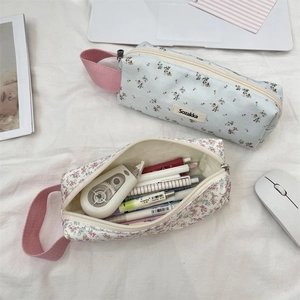 Detail of floral fabric pencil pouches with ribbon handles and large storage capacity