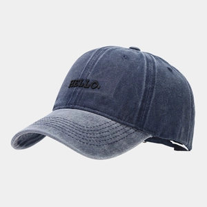 Detail of HELLO embroidery on vintage washed blue and grey contrast baseball cap