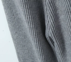 Macro shot of grey knitted set fabric showing vertical ribbed texture and high-quality yarn