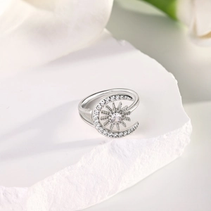 Macro view of sterling silver star and moon ring with white zircon stones on stone