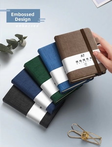 Detail view of A7 pocket notebooks in five colors with elastic bands and pen holders