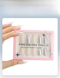 Silver glitter gradient press-on nails set with pink packaging shown by hand model
