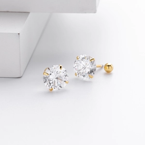 Macro detail of gold S925 sterling silver screw back stud earrings with 4-claw cubic zirconia