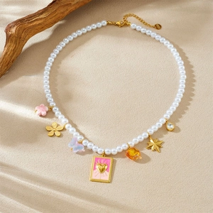 Chic pearl necklace with pink heart pendant, butterfly charms and gold star details