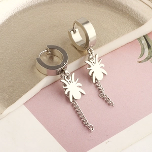 Macro shot of silver gothic spider charm earring with hanging metal tassel chain