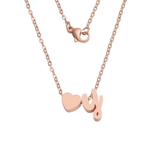 Detail of rose gold heart pendant with lowercase letter y on a dainty link chain