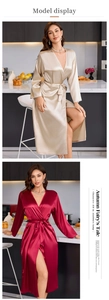 Close-up of champagne and burgundy silk bathrobes with luxurious glossy satin texture