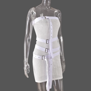 Detail of white tube mini dress with silver buckles and long decorative straps