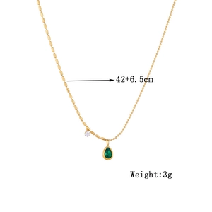 Gold chain necklace featuring a green teardrop pendant and small white stone detail