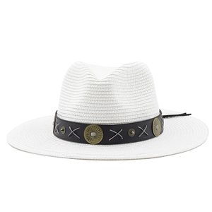 Detail of white straw fedora featuring a black leather band with sunburst metal buckle