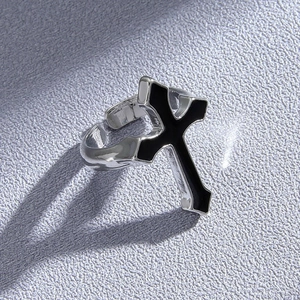 Detail view of adjustable silver cross ring with black enamel oil drip punk style