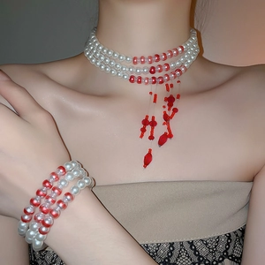 Detailed view of elegant triple-layer pearl and red bead necklace with matching bracelet
