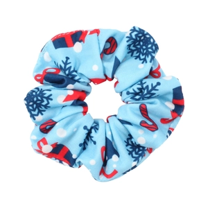 Detail of light blue Christmas scrunchie featuring gift boxes and candy cane patterns