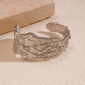 Detailed macro view of wide open cuff bracelet with crinkled silver lava texture
