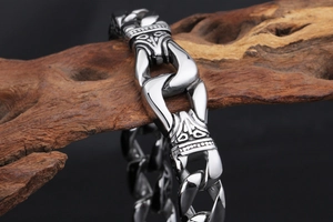 Macro view of silver vintage Viking engraved bracelet on a natural wood base