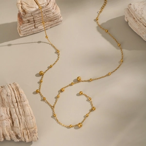 Minimalist 18K gold ball Y-necklace on natural stones for a sophisticated look