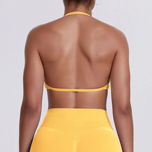 Detailed back view of yellow seamless sports bra with cross straps and high waist leggings