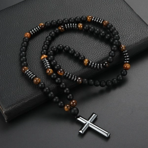 Vintage African pine and tiger eye stone beaded cross necklace for men on black book