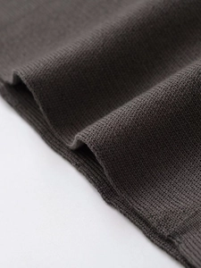 Macro shot of dark grey knit fabric with rib-knit cuffs and fine stitching detail