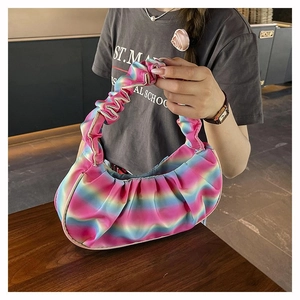 Detail showing rainbow gradient pleated shoulder bag with soft satin texture and vibrant colors