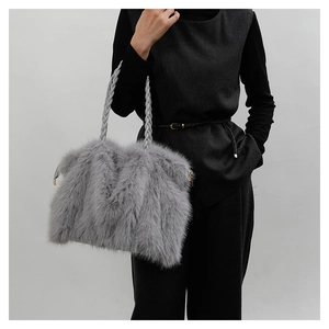 Close-up of gray plush tote bag featuring fluffy texture and braided handle details