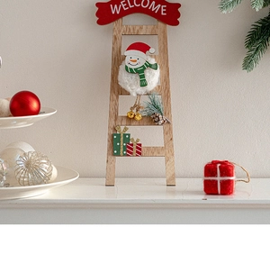 Detail of wooden Christmas welcome ladder with plush snowman, pine needles and metal bell