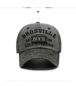 Detailed close-up of vintage washed denim baseball cap with 3D letter embroidery in dark grey