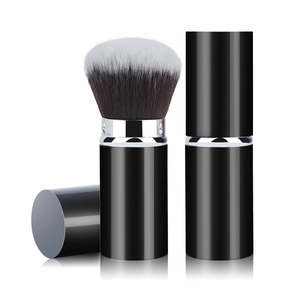 Macro detail of the portable retractable makeup brush with black and white gradient bristles
