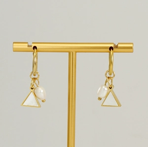 Detail of 18K gold earrings with triangle mother-of-pearl and irregular white pearls
