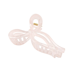 Close-up of a pink bow hair claw clip made of translucent resin with a gold metal spring