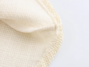 Macro shot of French tweed dress fabric texture and professional hemmed edge