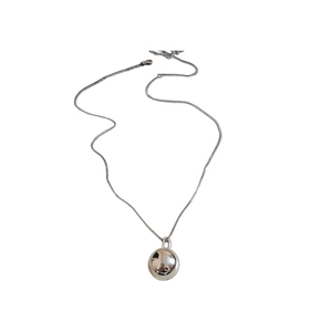 Minimalist silver stainless steel necklace with a polished sphere pendant on a thin chain