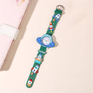 Macro detail of kids watch with green 3D rocket silicone strap and blue UFO dial case