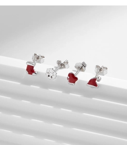 Close-up of S925 sterling silver Christmas stud earrings including snowflake and hat