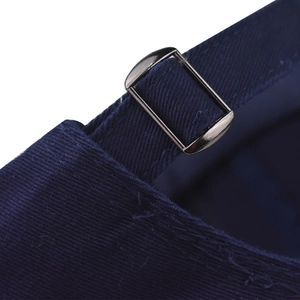 Macro detail of navy cotton twill cap featuring a premium dark gunmetal adjustable buckle