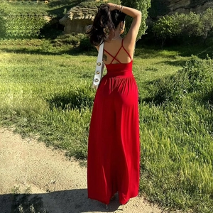 Detail of cross-back straps and open back design on this red wide-leg summer jumpsuit