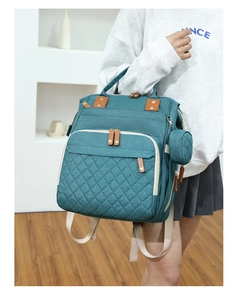 Peacock blue quilted diaper backpack with side pendant and brown leather accents