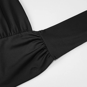 Detail of delicate pleating and stitching on the black halter neck dress fabric