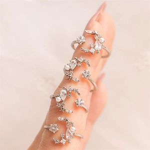 Star and moon silver open rings set with zircons and pearls worn on fingers