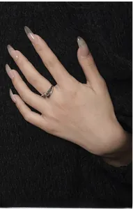 Close-up of S925 silver Z-shaped wavy ring with textured finish and black inlay detail