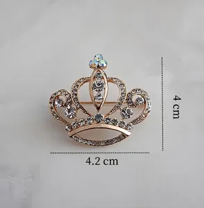 Detail view of crystal crown brooch with 4 cm height and 4.2 cm width dimensions
