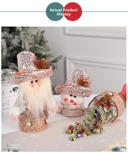 Close-up of pink and gold Santa and snowman candy jars with shimmering fabric detail