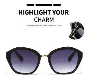 Detail of polygonal black sunglasses showing golden bridge and purple gradient lenses