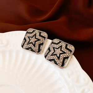 Elegant square silver stud earrings with black enamel and sparkling diamond star