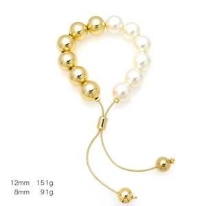 Detail of adjustable pearl and 18k gold plated bead bracelet showing textures and sizing