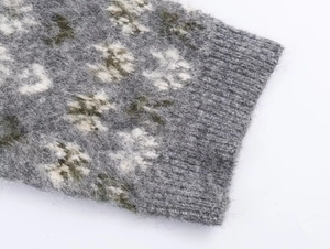 Macro shot of gray jacquard knit sweater with soft mohair texture and ribbed edge detail